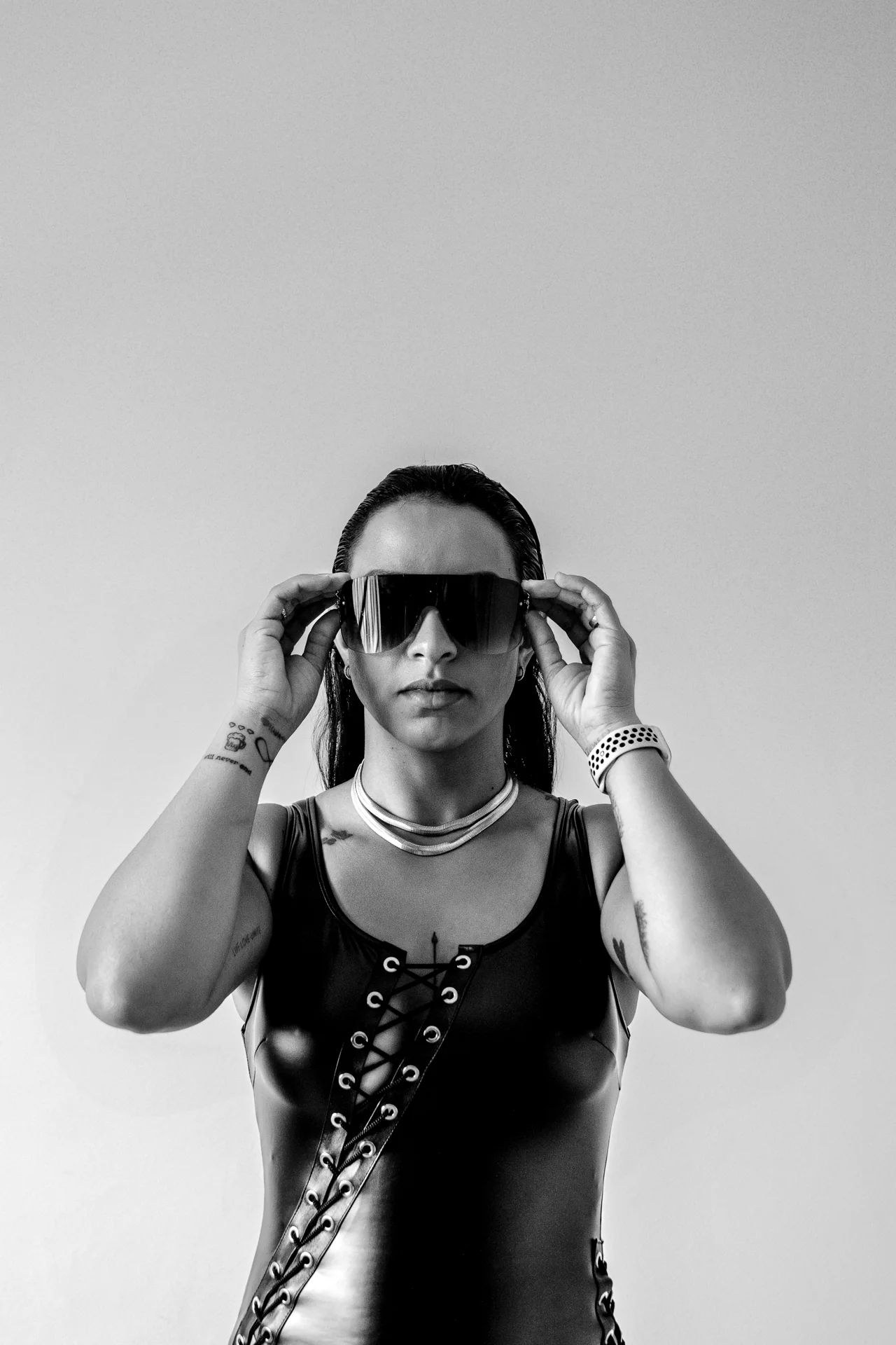Darah holding her headphones in the studio